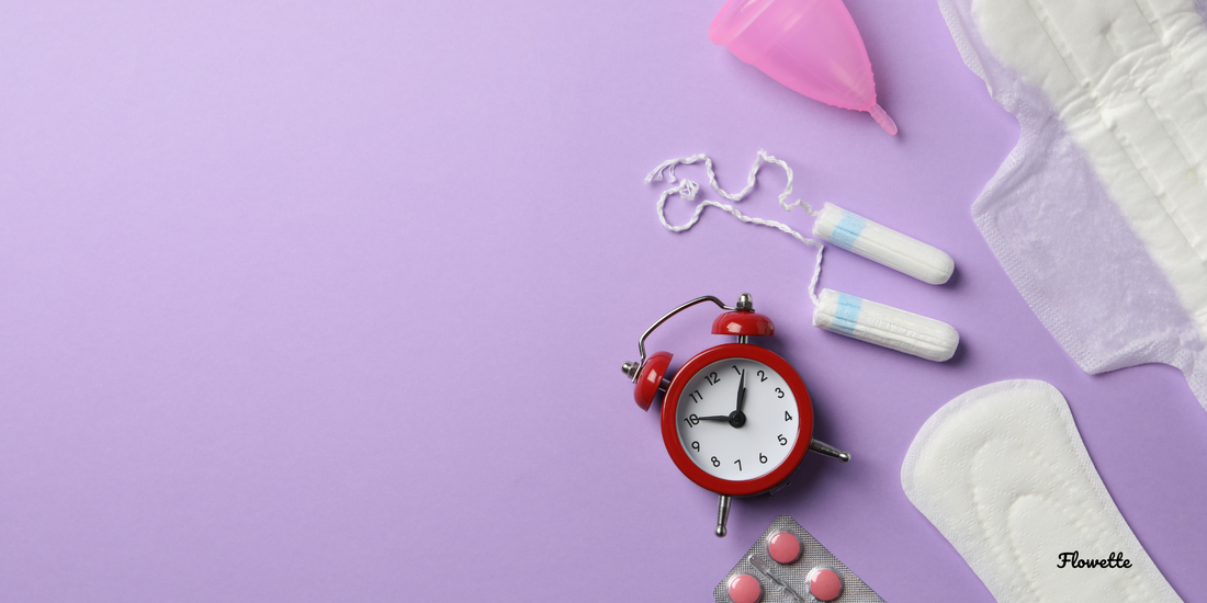 picture of tampons, menstrual cups, pads, painkillers and a clock purple background