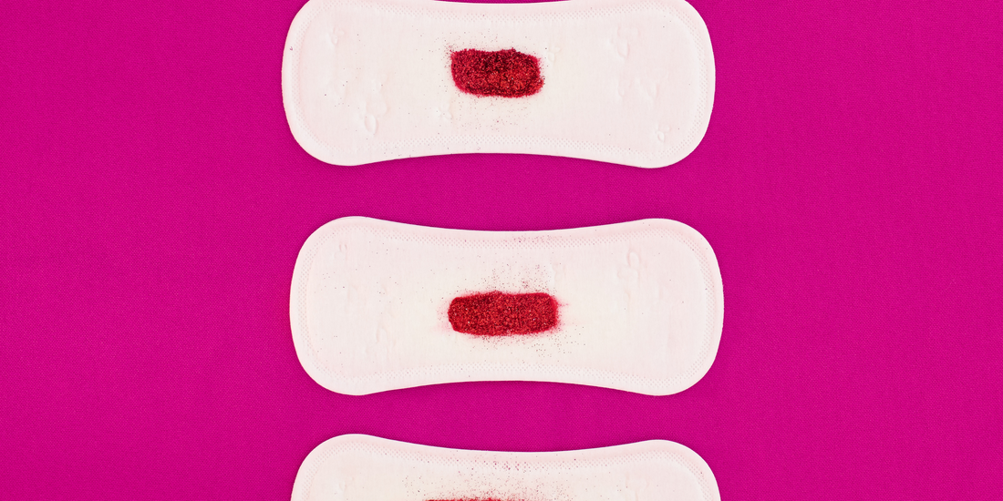 white always period pads with glitter representing blood on a pink background